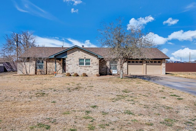 ranch-style house featuring a garage, brick siding, driveway, and fence