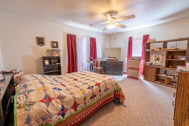 carpeted bedroom featuring ceiling fan and multiple windows