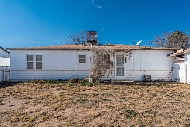 back of property with a lawn and cooling unit