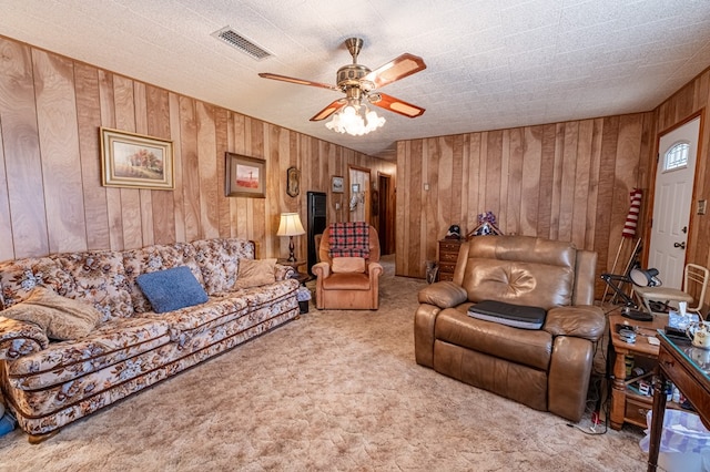 carpeted living room featuring ceiling fan