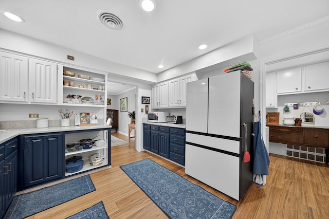4502 Green Tree Blvd, Midland, TX 79707 - kitchen featuring open shelves, white appliances, blue cabinets, white cabinetry, and light wood finished floors