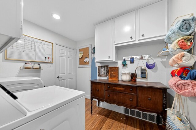 4502 Green Tree Blvd, Midland, TX 79707 - laundry area featuring independent washer and dryer, light wood finished floors, cabinet space, and recessed lighting