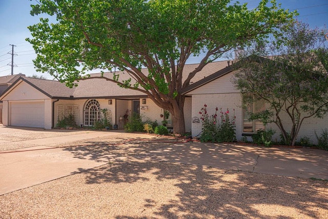 4502 Green Tree Blvd, Midland, TX 79707 - ranch-style house featuring brick siding, driveway, and an attached garage