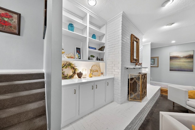 4502 Green Tree Blvd, Midland, TX 79707 - bar featuring crown molding, stairway, a textured ceiling, and a brick fireplace