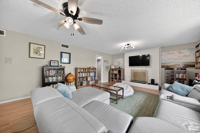 4502 Green Tree Blvd, Midland, TX 79707 - living area with wood finished floors, a textured ceiling, and a ceiling fan