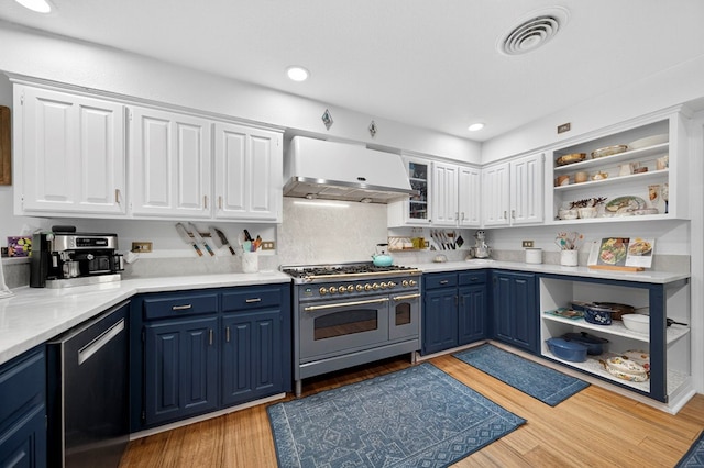 4502 Green Tree Blvd, Midland, TX 79707 - kitchen featuring double oven range, extractor fan, blue cabinetry, open shelves, and recessed lighting
