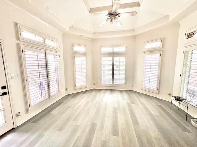 spare room with crown molding, ceiling fan, a wealth of natural light, and wood finished floors