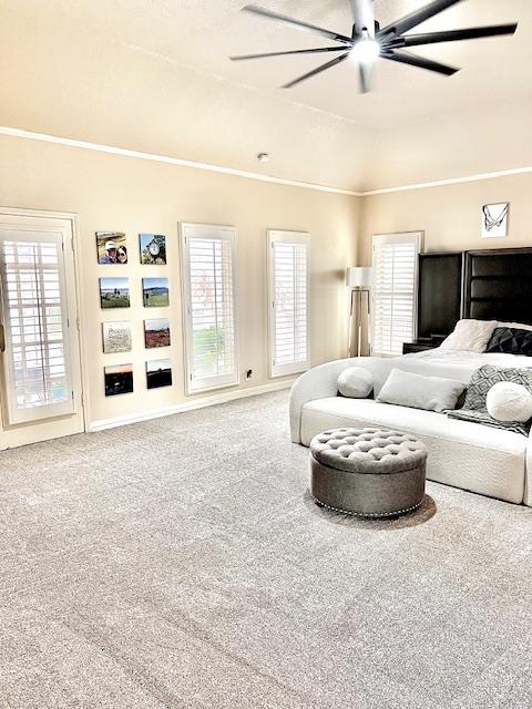 carpeted bedroom with crown molding, multiple windows, and a ceiling fan