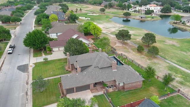 birds eye view of property featuring a water view, golf course view, and a residential view