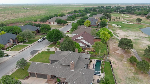 drone / aerial view with a residential view and golf course view