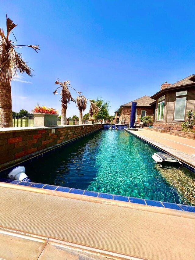 view of swimming pool featuring a fenced in pool