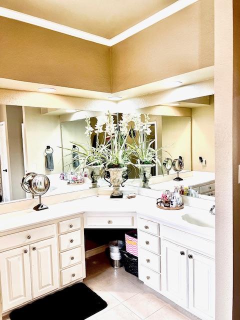 full bathroom featuring tile patterned floors, ornamental molding, and vanity