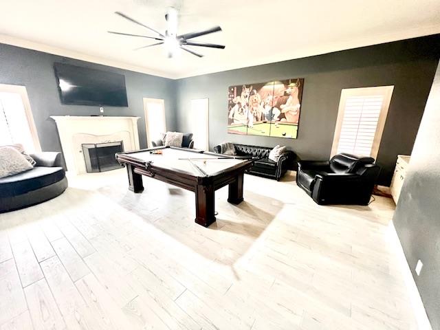 rec room with a ceiling fan, billiards, wood finished floors, and a fireplace