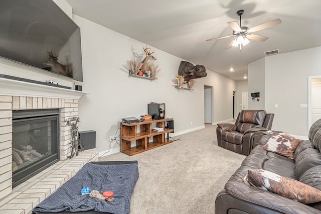 living area with a fireplace, lofted ceiling, light colored carpet, visible vents, and baseboards