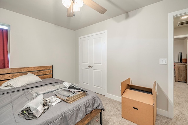 bedroom featuring light colored carpet, ceiling fan, visible vents, and baseboards