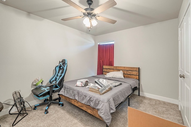 carpeted bedroom with a ceiling fan and baseboards