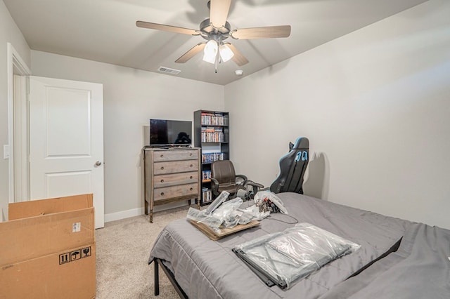 bedroom featuring a ceiling fan, visible vents, light carpet, and baseboards