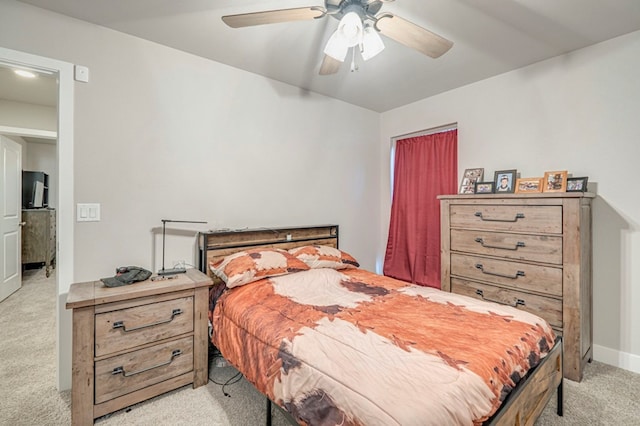 bedroom featuring a ceiling fan and light colored carpet