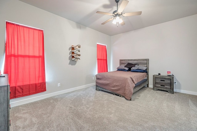 bedroom with a ceiling fan, carpet flooring, and baseboards