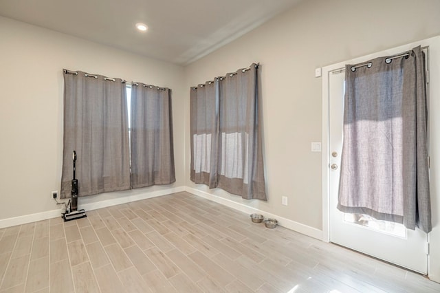 unfurnished room with recessed lighting, light wood-type flooring, and baseboards