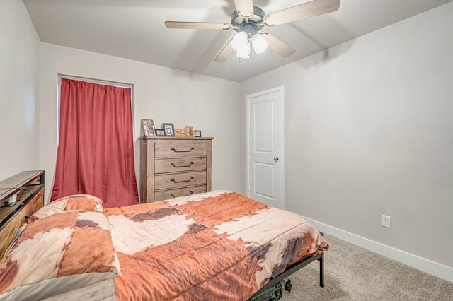 carpeted bedroom with ceiling fan and baseboards