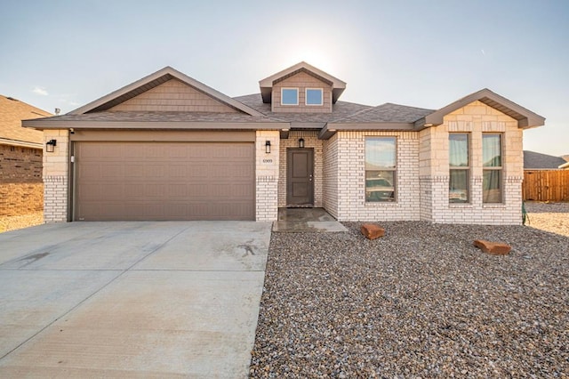 view of front of house with a garage, brick siding, driveway, and a shingled roof