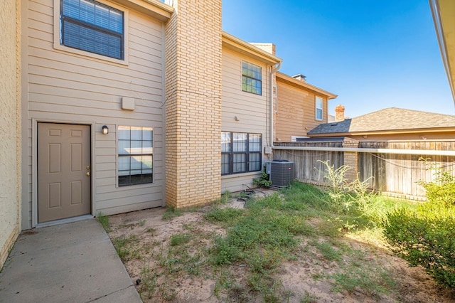 rear view of house featuring central AC unit