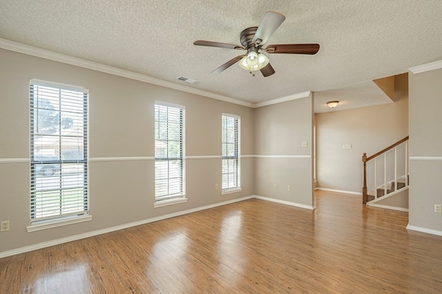 spare room with hardwood / wood-style flooring and a wealth of natural light