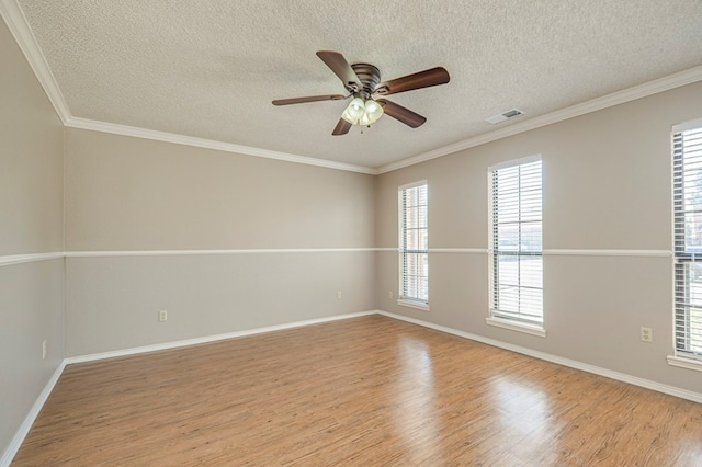 spare room featuring ornamental molding, a textured ceiling, and light hardwood / wood-style floors