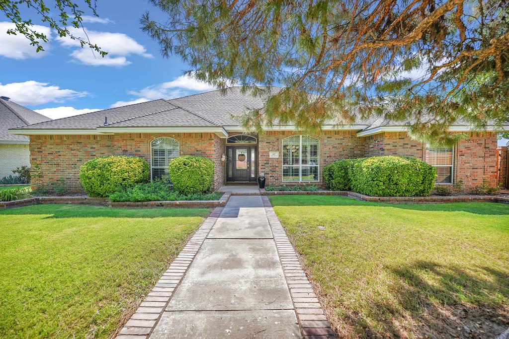 ranch-style home with a front lawn