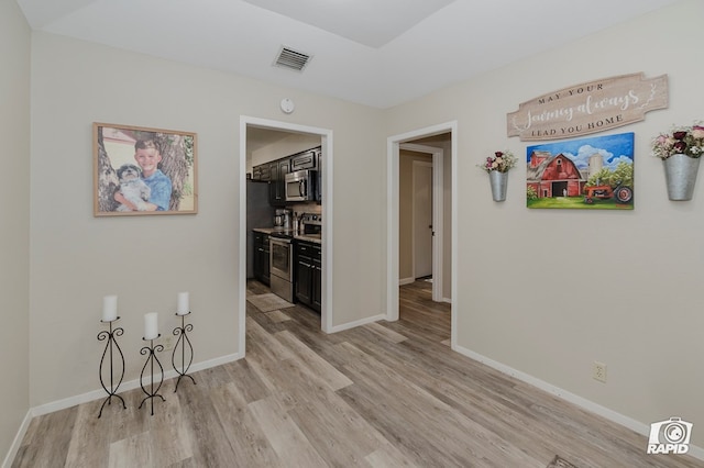 4313 Downing Ave, Midland, TX 79707 - spare room featuring light wood-type flooring, baseboards, and a smoke detector