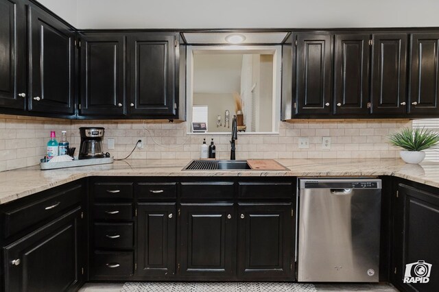 4313 Downing Ave, Midland, TX 79707 - kitchen with dishwasher, dark cabinets, a sink, backsplash, and light stone countertops