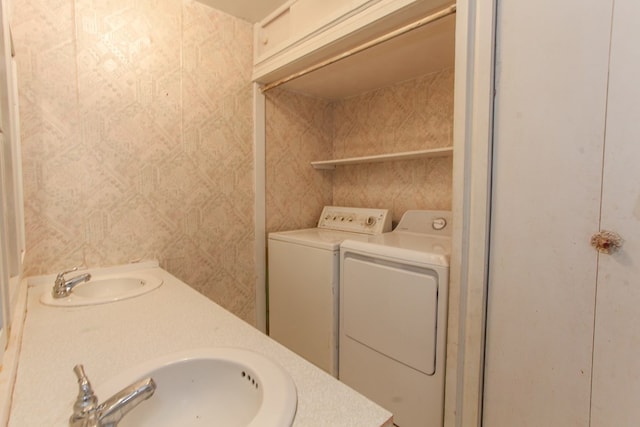 washroom with washer and dryer and sink