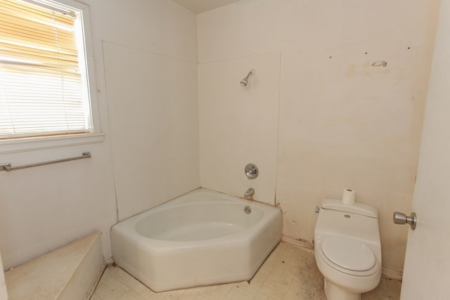 bathroom featuring a bath and toilet