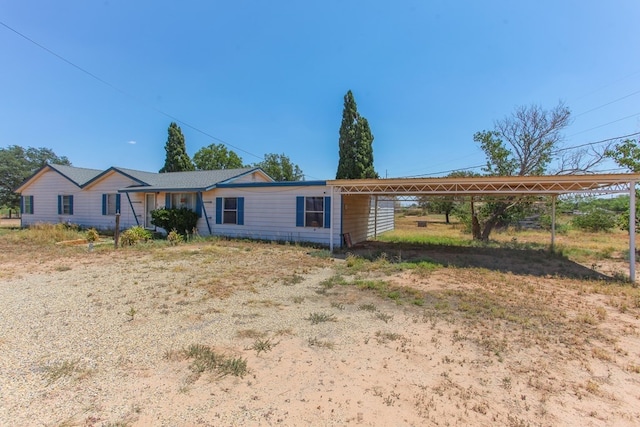 single story home featuring a carport