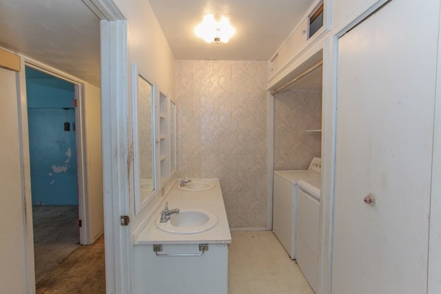 bathroom with washing machine and clothes dryer and vanity