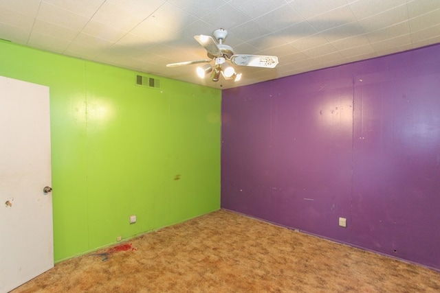 spare room with carpet floors and ceiling fan