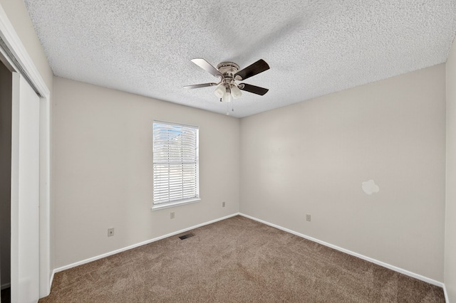 3208 Preston Dr, Midland, TX 79707 - unfurnished bedroom featuring a closet, carpet flooring, a textured ceiling, and ceiling fan