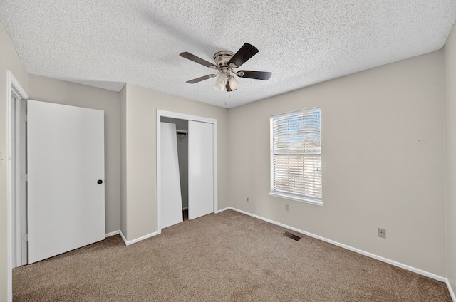 3208 Preston Dr, Midland, TX 79707 - unfurnished bedroom featuring carpet floors, a textured ceiling, a closet, and ceiling fan