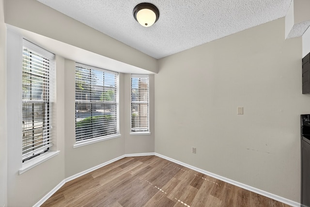 3208 Preston Dr, Midland, TX 79707 - spare room with wood finished floors and a textured ceiling