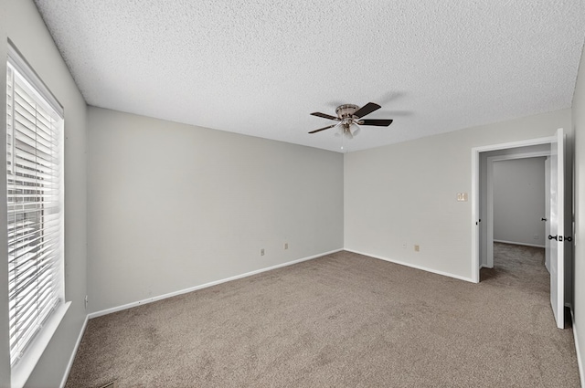 3208 Preston Dr, Midland, TX 79707 - unfurnished bedroom featuring carpet flooring, multiple windows, a textured ceiling, and ceiling fan