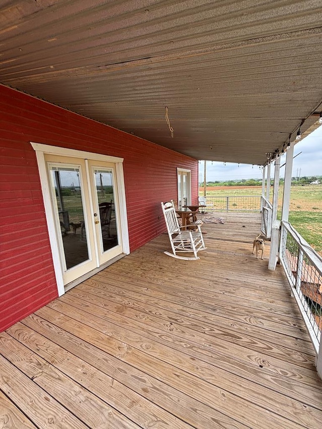 wooden terrace featuring french doors and a rural view