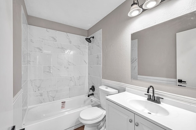 full bath with toilet, a textured wall, vanity, and washtub / shower combination