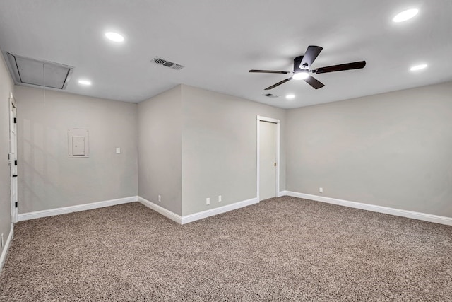 carpeted empty room featuring baseboards, visible vents, attic access, and recessed lighting