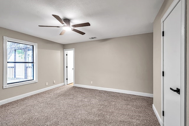 unfurnished bedroom featuring carpet, visible vents, ceiling fan, and baseboards