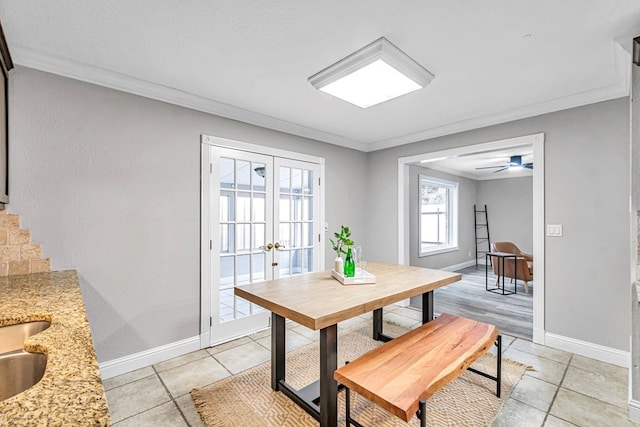 dining area featuring french doors, light tile patterned flooring, crown molding, and baseboards