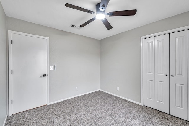 unfurnished bedroom with a ceiling fan, visible vents, baseboards, a closet, and carpet