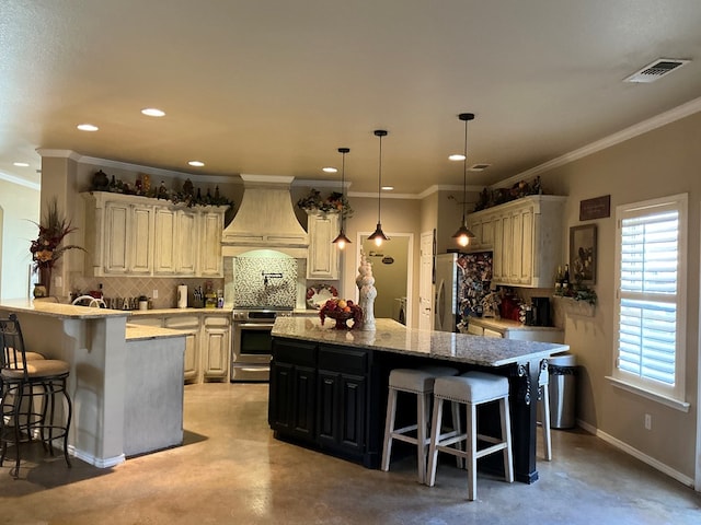 kitchen with premium range hood, a breakfast bar, ornamental molding, and appliances with stainless steel finishes