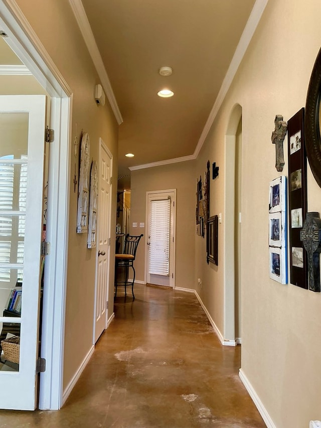 hallway featuring concrete floors and crown molding