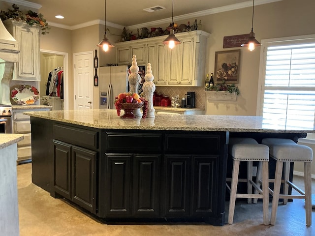 kitchen with stainless steel fridge with ice dispenser, light stone counters, ornamental molding, and backsplash